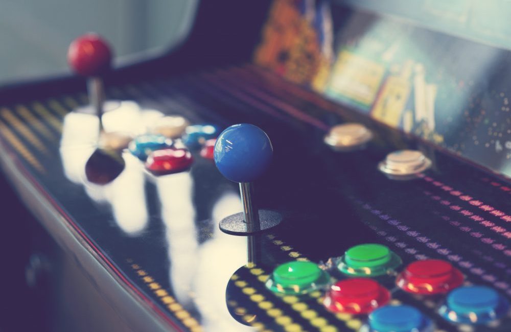 A close up of the control board on an olde fashioned arcade game