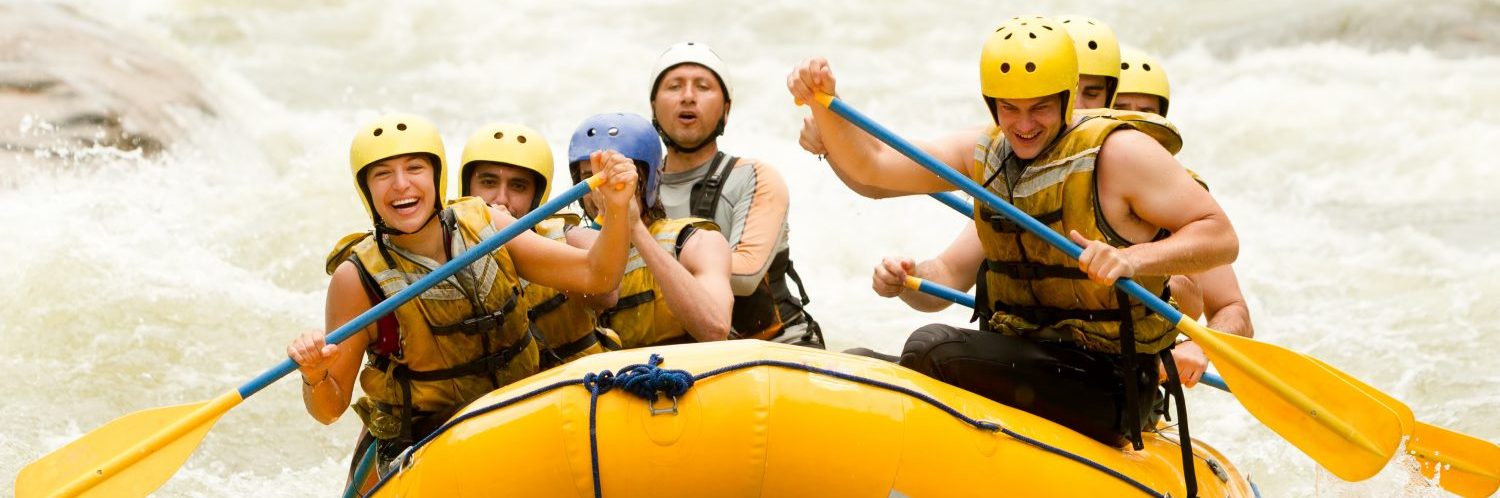 Group Of Mixed Tourist Men And Women With Guided By Professional Pilot On Whitewater River Rafting In Ecuador