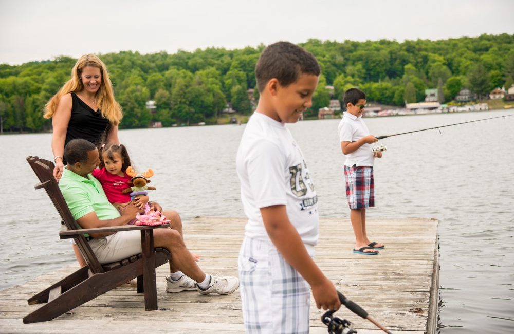 A family on a dock with the two boys fishing