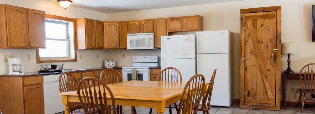 Demonstrating the kitchen and dining area in one of the vacation rentals.