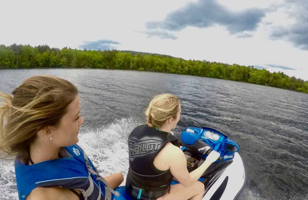 Two girls on a jet ski on the lake